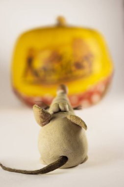 Figures Of Rats And A Piece Of Cheese On White Background. Statuette of mouse, close up. New Year concept. Selective focus
