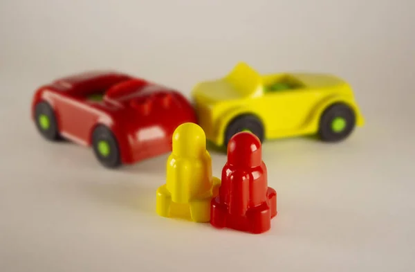 Two desperate men near toy cars involved in accident, conceptual image with miniatures and figurines isolated on white background. Close-up of a collision of two toy cars on a white background. — Stock Photo, Image