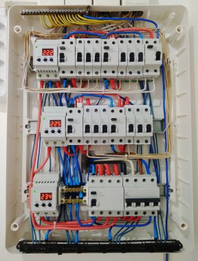 Automatic switches with wires in electrical shield close up. Electrical shield with automatic switches of electricity in the house - electricity control panel with circuit