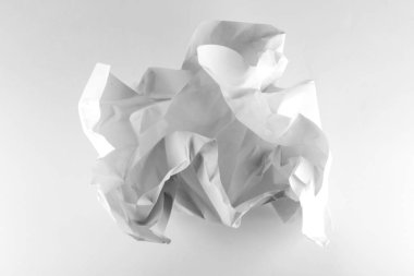 White crumpled paper ball on white background with clipping path. Close-up of crumpled paper ball
