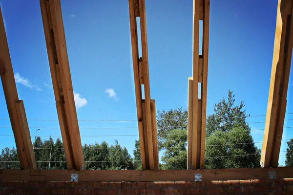 Střešní trámy nepokryté keramickými dlaždicemi na samostatně stojícím domě ve výstavbě, viditelné střešní prvky, baterky, pulty, trámy. Průmyslový střešní systém dřevěné dřevo, trámy a šindele — Stock fotografie