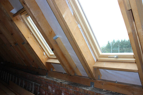 Roofing construction and building new house with skylights, new brick house with chimney. Modern Roof Skylight. Attic Skylights Home Design. Roofing Construction. Clay Roof Tiles.