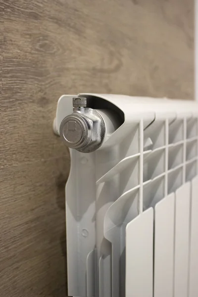 White heating radiator heat the room. Heating Radiator, White radiator in an apartment