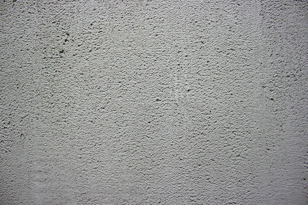 Textura de concreto e gesso na parede. Linhas onduladas no gesso. Textura de concreto e gesso. Textura de gesso decorativo ou estuque de perto, fundo de pedra cinza abstrato — Fotografia de Stock