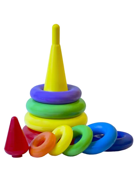 Children's plastic toy pyramid in a packing grid on a white background. Children's activity game for learning colors and shapes — 图库照片