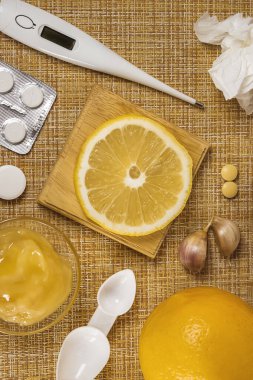 Treatment of colds and flu. Various medications, cold pills, throat spray, nasal drops, and a paper napkin on a brown background. Treatment of influenza. Medicine flat lay