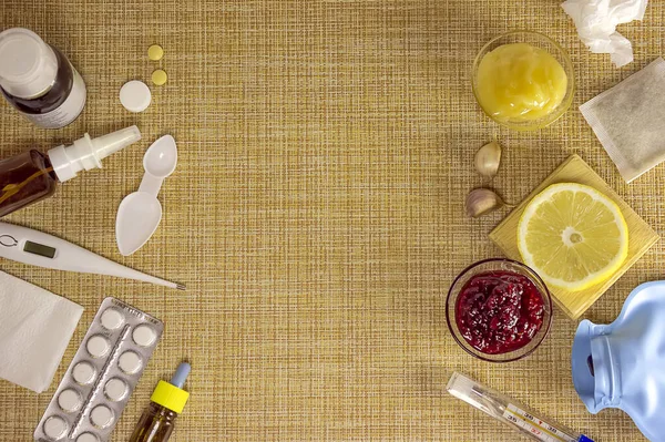 Traditional And Modern Cold Medicine. Treatment of colds and flu. Sick day and flu concept. Various medicines, a thermometer, sprays from a stuffy nose on brown background. Copy space.