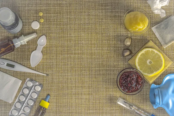 Traditional And Modern Cold Medicine. Treatment of colds and flu. Sick day and flu concept. Various medicines, a thermometer, sprays from a stuffy nose on brown background. Copy space.