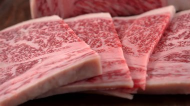 Thick slice of Japanese wagyu beef ready to be cooked on a barbecue