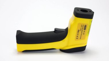 Beyaz arkaplanda sarı kızılötesi termometre tabancası