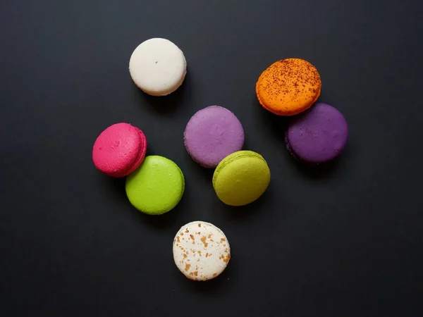 layout of colored macaroons on a solid color background