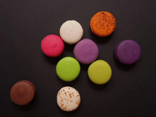 layout of colored macaroons on a solid color background