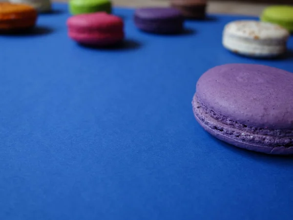 layout of colored macaroons on a solid color background