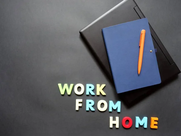 layout of a laptop, pen, notebook on the surface for remote work