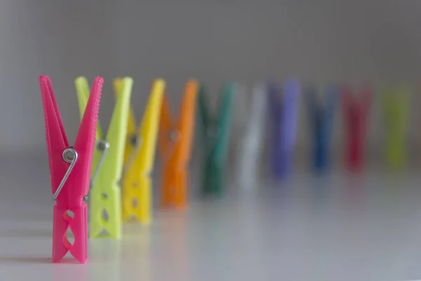 Sıraya dizilmiş renkli plastik mandallar grubu - ilk mandal odaklı