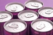 Close up of Tops of Purple Soda Cans in Studio with Purple Background