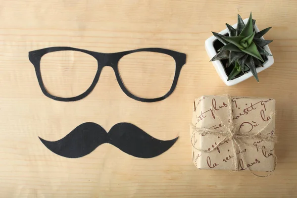 A gift for a man, a mustache and glasses