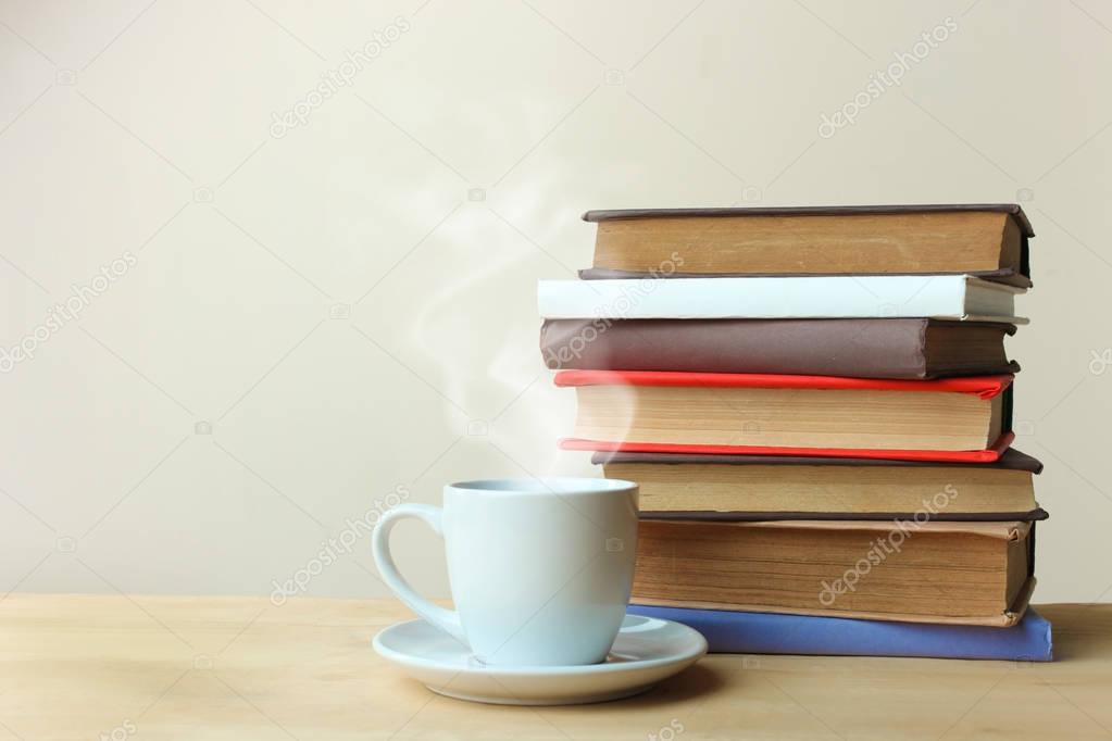 A stack of books and a cup of tea