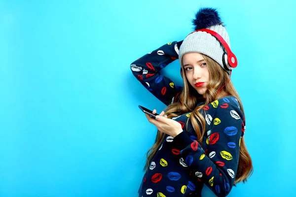 Girl on headphones with a smartphone — Stock Photo, Image