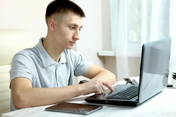 The guy works behind a laptop — Stock Photo, Image
