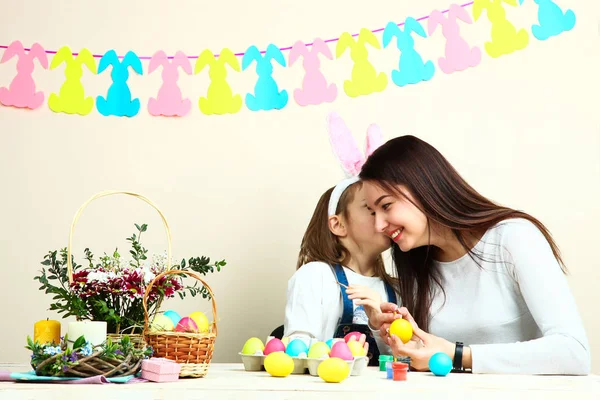 Mother and little daughter coloring Easter eggs — Stock Photo, Image