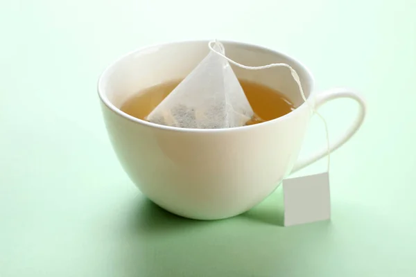 Mint tea bag in a cup — Stock Photo, Image