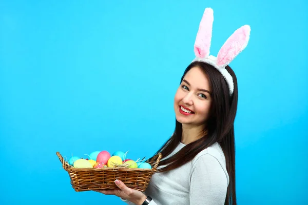 Beautiful woman with a basket of Easter eggs — Stock Photo, Image