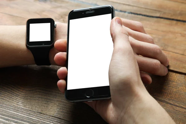 Men's hands with smart watch and smartphone — Stock Photo, Image