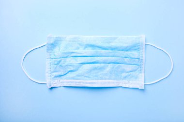 Mavi arka planda mavi tıbbi maske. Salgın konsepti