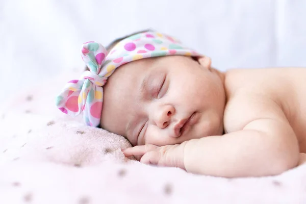 Adorable bebé recién nacido con una diadema que duerme en el estómago —  Fotos de Stock