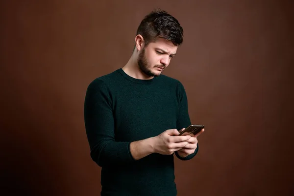 Man with brown hair texting message