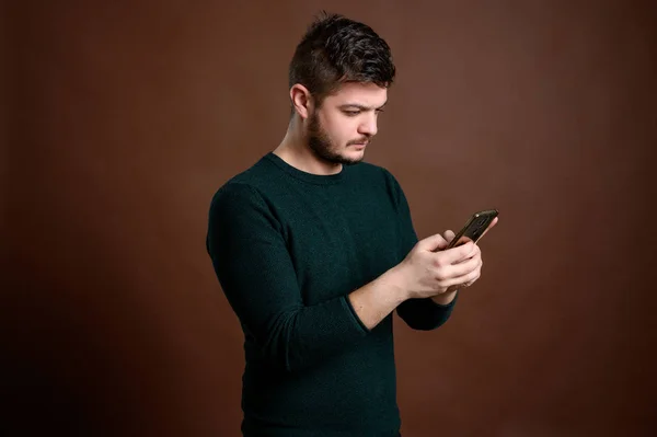 Man with brown hair texting message