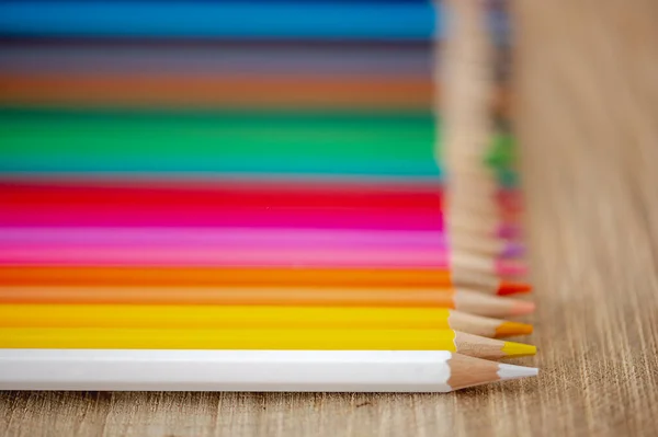 天然木材背景上彩虹色铅笔的特写 — 图库照片