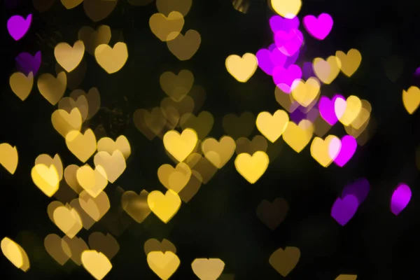 Аннотация Yellow Purple lights Heart bokeh background — стоковое фото