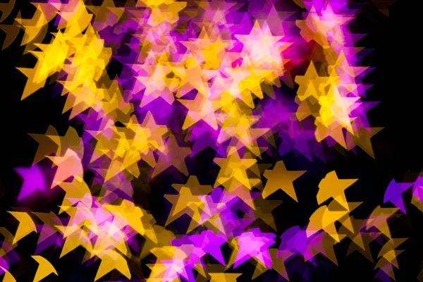 Abstrakt gul lila ljus Star bokeh bakgrund — Stockfoto