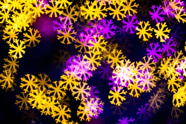 Abstract Yellow Purple lights snow flake bokeh background