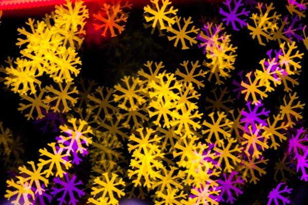 Abstract Yellow Purple lights snow flake bokeh background