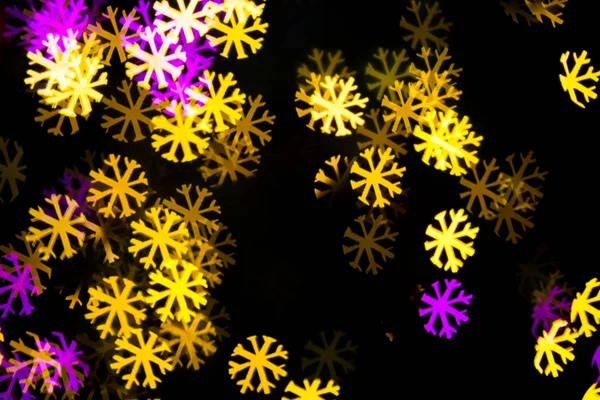 Abstrakt gul lila ljus snow flake bokeh bakgrund — Stockfoto