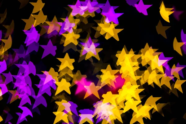 Resumen Amarillo Púrpura luces Star bokeh fondo —  Fotos de Stock