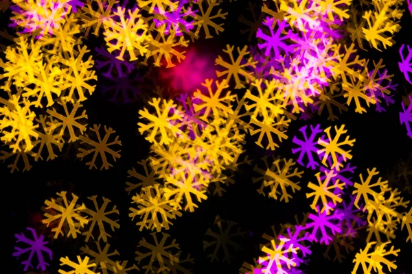 Abstract Yellow Purple lights snow flake bokeh background