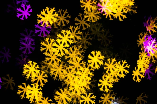 Abstract Yellow Purple lights snow flake bokeh background