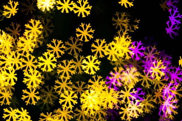 Abstract Yellow Purple lights snow flake bokeh background