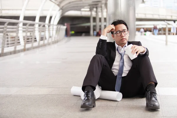 Stressful businessman or engineer sitting outdoor thoughtful thi Royalty Free Stock Photos