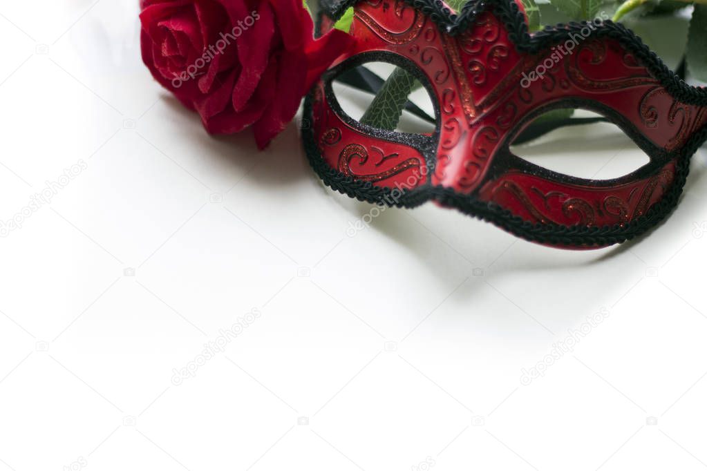 Venice carnival mask and red rose on white background isolated