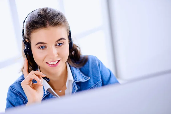 Female technical support agent in office working on computer
