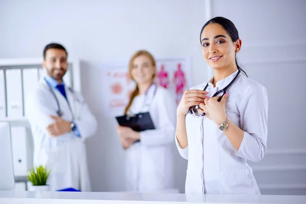 Femmina Sorridente Arabo Dottore Piedi Fronte Alla Sua Squadra Ospedale — Foto Stock