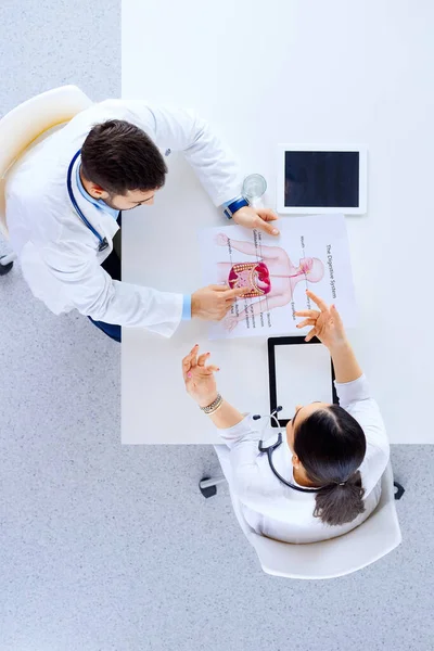 Hastane Masasında Tabletlerle Oturup Tartışan Doktorlardan Oluşan Tıbbi Bir Ekip — Stok fotoğraf