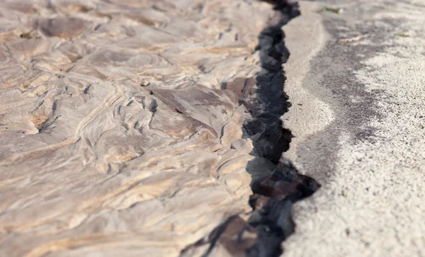 Sand surface after the rain with the relief formed by water currents.