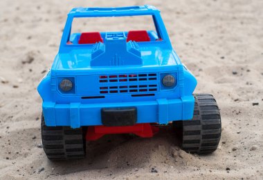 Blue toy car on the sand