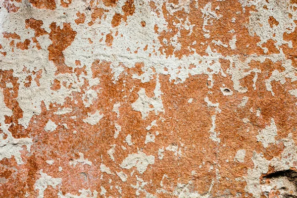 Surface de béton avec les restes de blanchisserie et de peinture orange — Photo